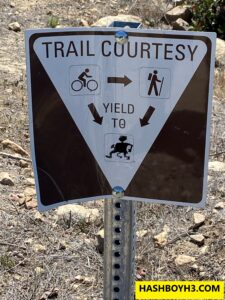 Hash Boy Trail Courtesy Sign indicating Bicyclists and Hikers are required to yield the trail to Hash Boy.